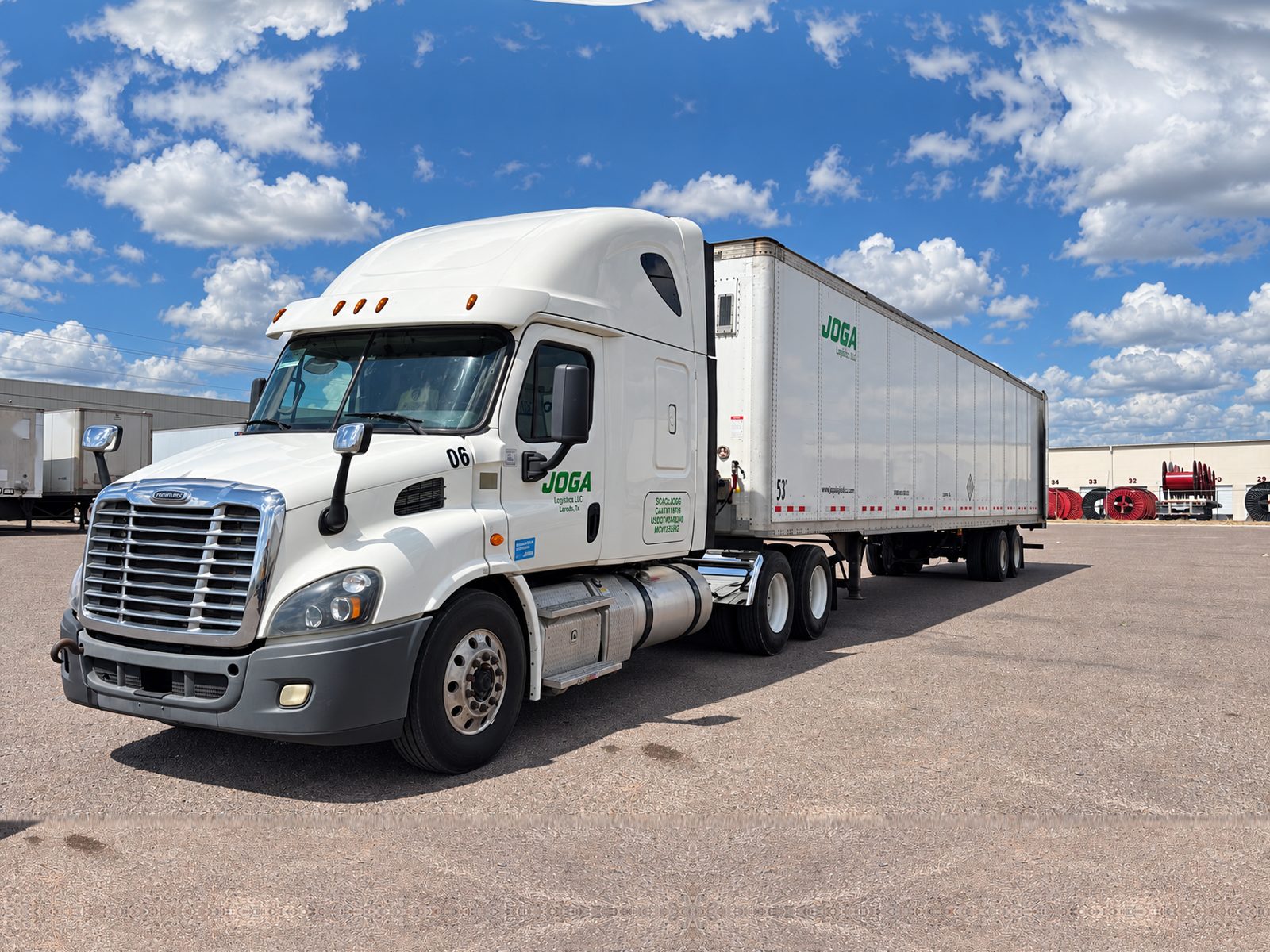 White JOGA tractor, unit 06, with a JOGA 53-foot trailer